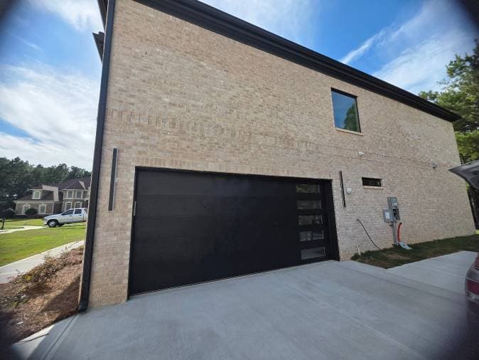 Project Elevate Your Home with Our Sleek Black Garage Doors image
